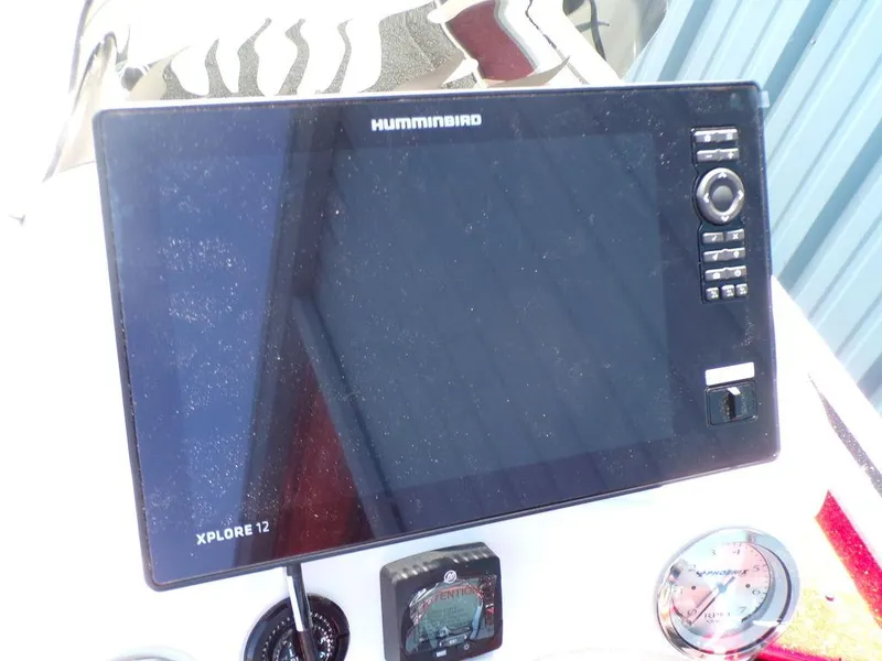 Slide: The Image of 2025 Phoenix 920 Elite boat dashboard featuring Humminbird Xplore 12 navigation system. - 3