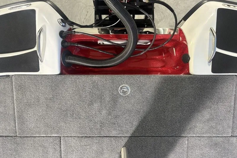 Slide: The Image of 2025 Phoenix 920 Elite boat deck with red accents and gray carpeting. - 32