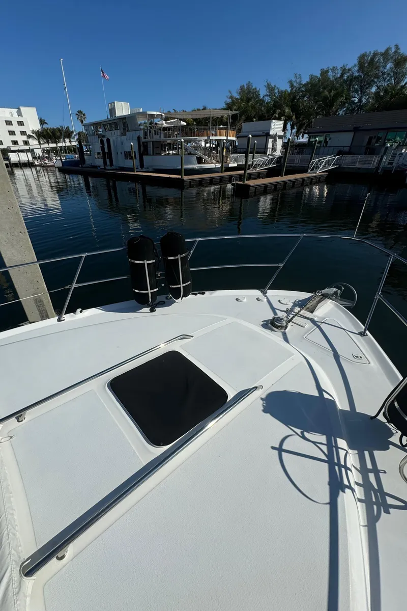 Slide: The Image of 1998 Sea Ray 400 Express Cruiser docked at marina, sunny day, calm waters. - 14