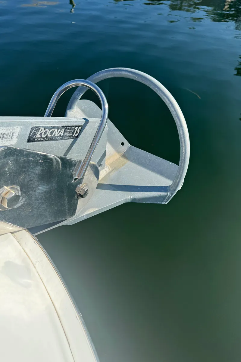 Slide: The Image of Rocna anchor on 1998 Sea Ray 400 Express Cruiser, docked in calm water. - 15