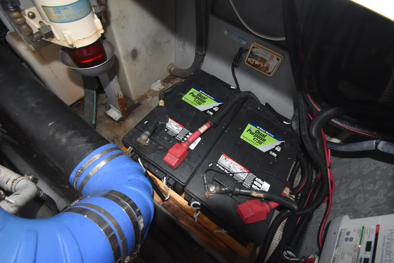 Slide: The Image of Engine compartment of 1998 Sea Ray 400 Express Cruiser with batteries and wiring. - 16