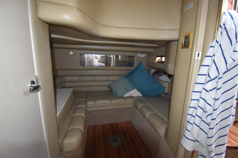 Slide: The Image of Interior cabin of 1998 Sea Ray 400 Express Cruiser with beige seating and cushions. - 6