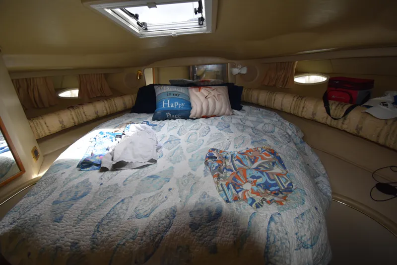 Slide: The Image of Cozy cabin interior of 1998 Sea Ray 400 Express Cruiser with bed and decorative pillows. - 8
