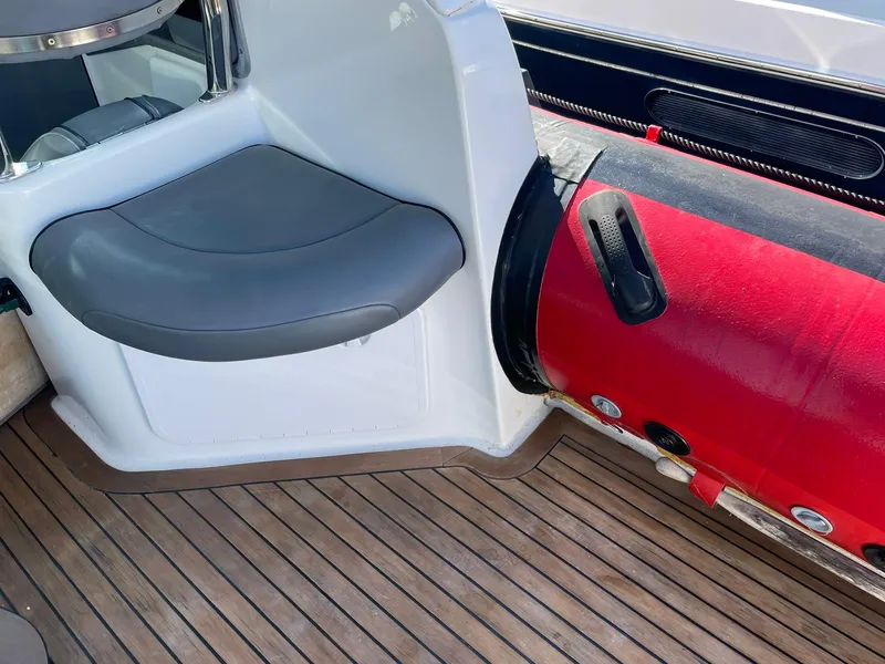 Slide: The Image of 2001 Protector Targa 28 boat interior with red inflatable tube and wooden deck. - 11
