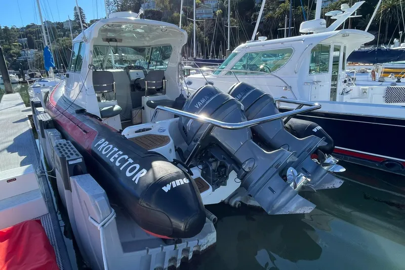 Slide: The Image of 2001 Protector Targa 28 boat docked with dual Yamaha engines. - 12
