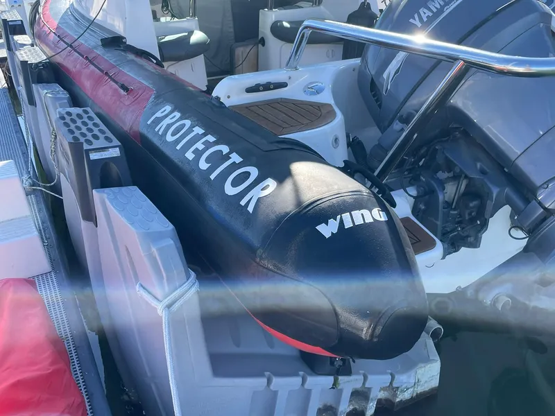 Slide: The Image of 2001 Protector Targa 28 boat with Yamaha engine, docked and ready for use. - 13