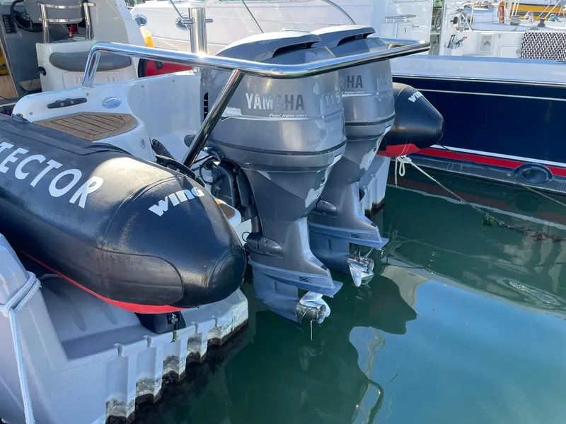 Slide: The Image of 2001 Protector Targa 28 boat with twin Yamaha outboard motors docked in marina. - 14