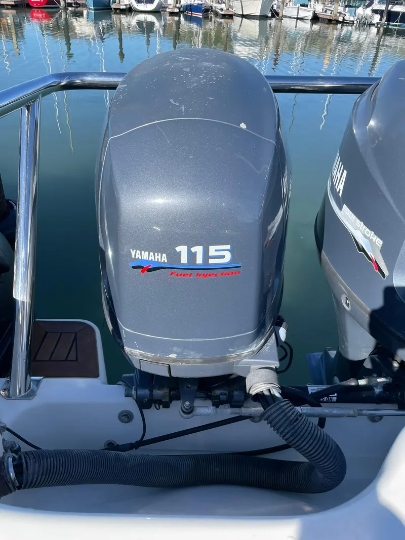 Slide: The Image of Yamaha 115 outboard motor on a 2001 Protector Targa 28 boat at a marina. - 15