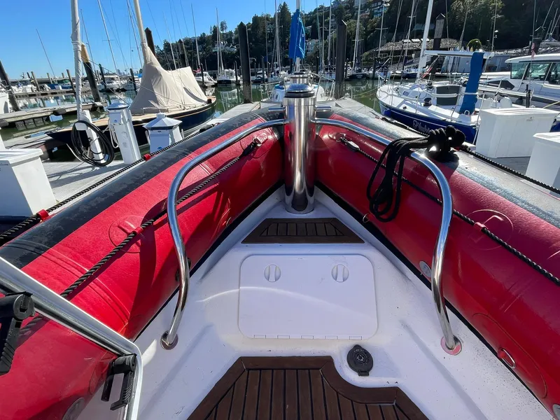 Slide: The Image of 2001 Protector Targa 28 boat bow with red inflatable sides, docked in a marina. - 16