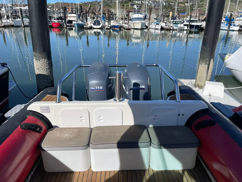 Slide: The Image of 2001 Protector Targa 28 boat with twin engines docked at a marina. - 21