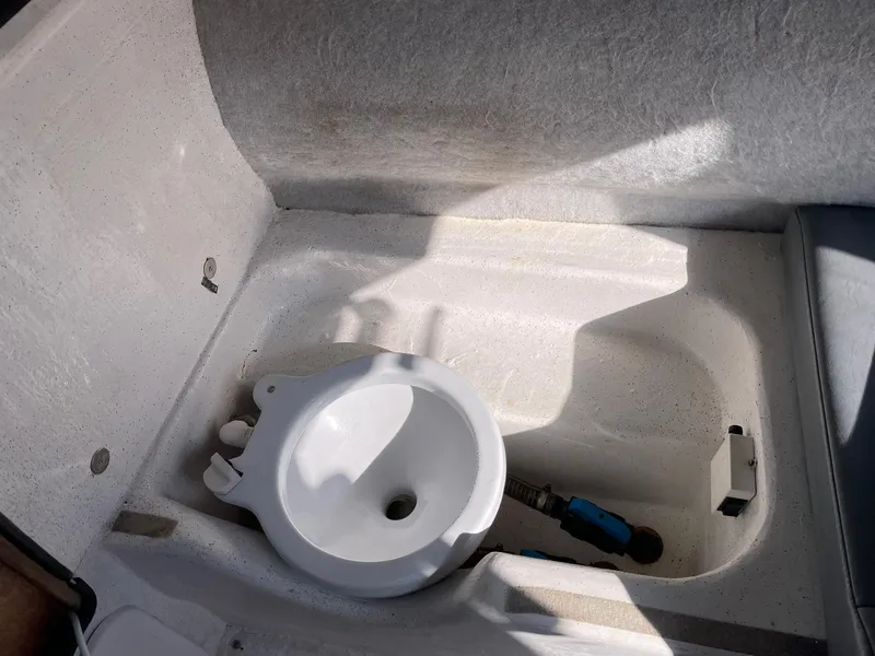 Slide: The Image of 2001 Protector Targa 28 boat interior with a compact sink and storage area. - 28