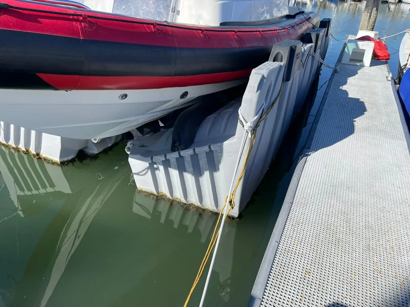Slide: The Image of 2001 Protector Targa 28 boat docked with inflatable fenders, side view. - 36