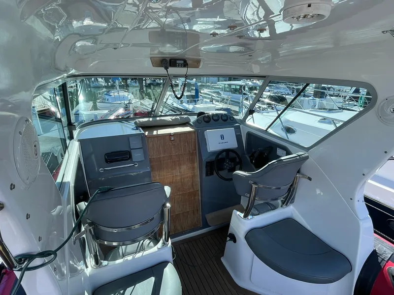 Slide: The Image of Interior of 2001 Protector Targa 28 boat with helm and seating area. - 7