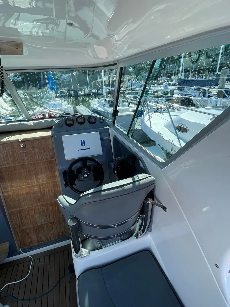 Slide: The Image of 2001 Protector Targa 28 boat interior with steering wheel and navigation controls. - 9