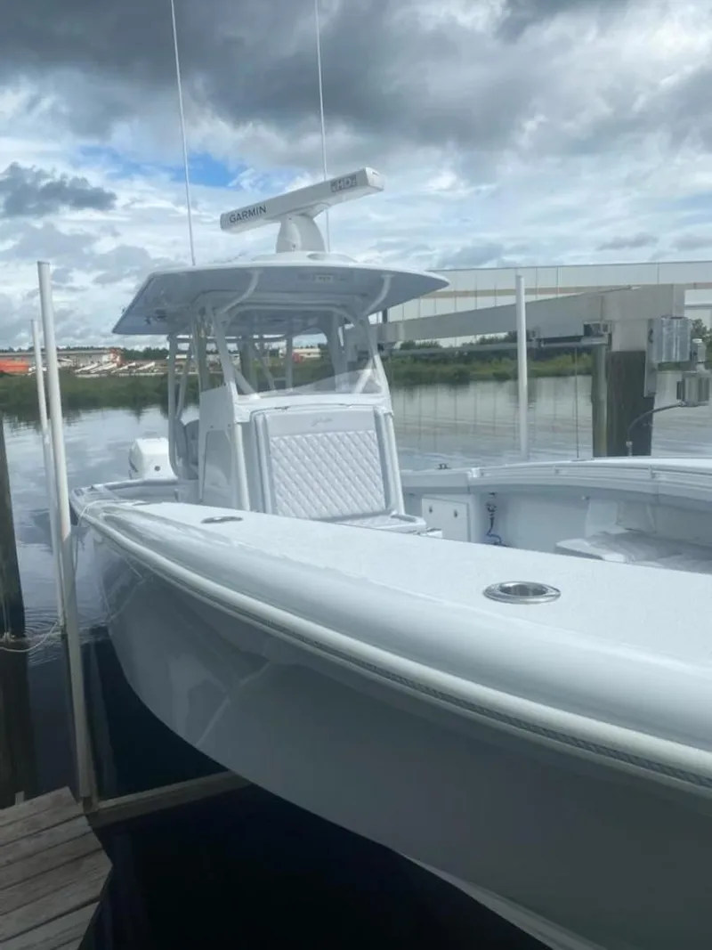 Slide: The Image of 2022 Yellowfin 32 boat docked by the water under cloudy skies. - 10