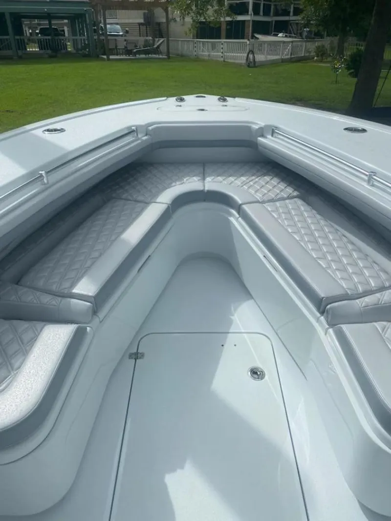 Slide: The Image of 2022 Yellowfin 32 boat interior with cushioned seating and sleek design. - 2