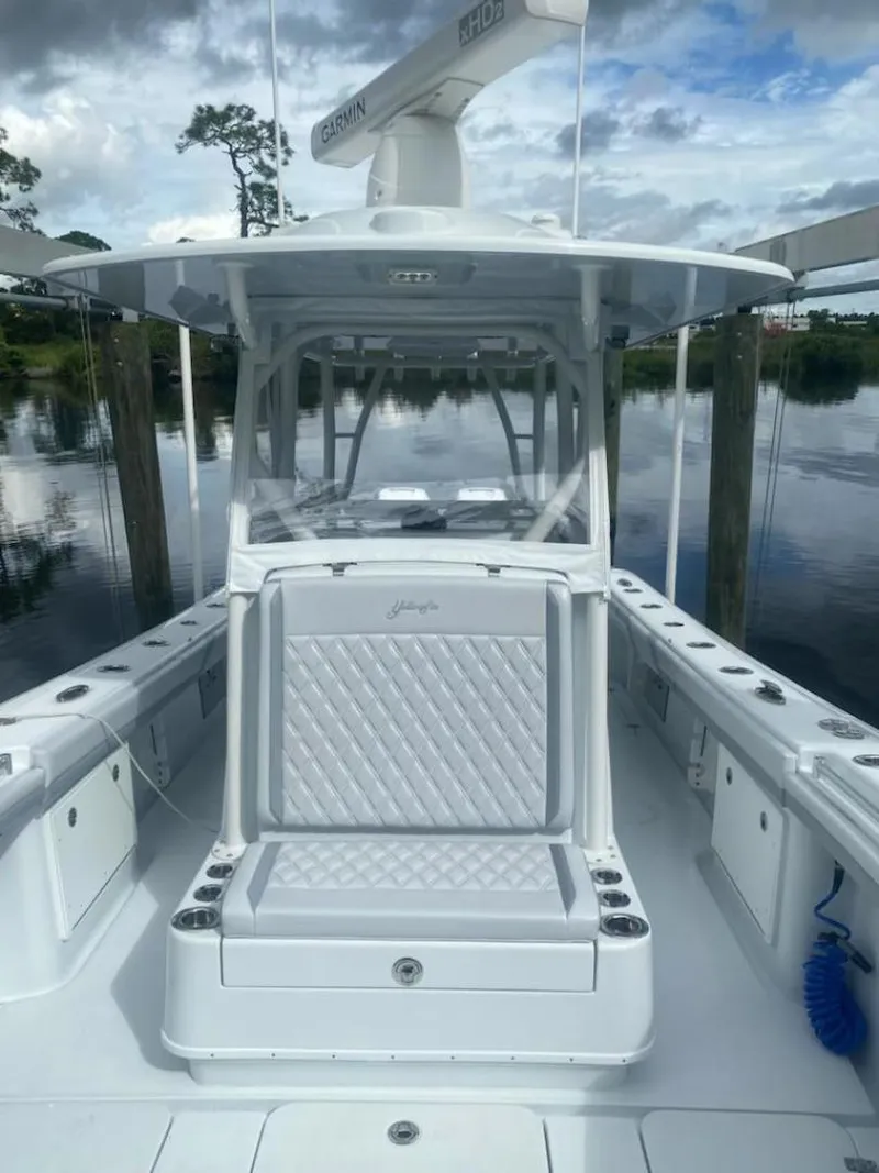Slide: The Image of 2022 Yellowfin 32 boat with sleek design, white seating, and spacious deck. - 5