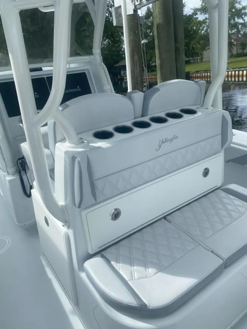 Slide: The Image of 2022 Yellowfin 32 boat interior with cushioned seating and cup holders. - 6