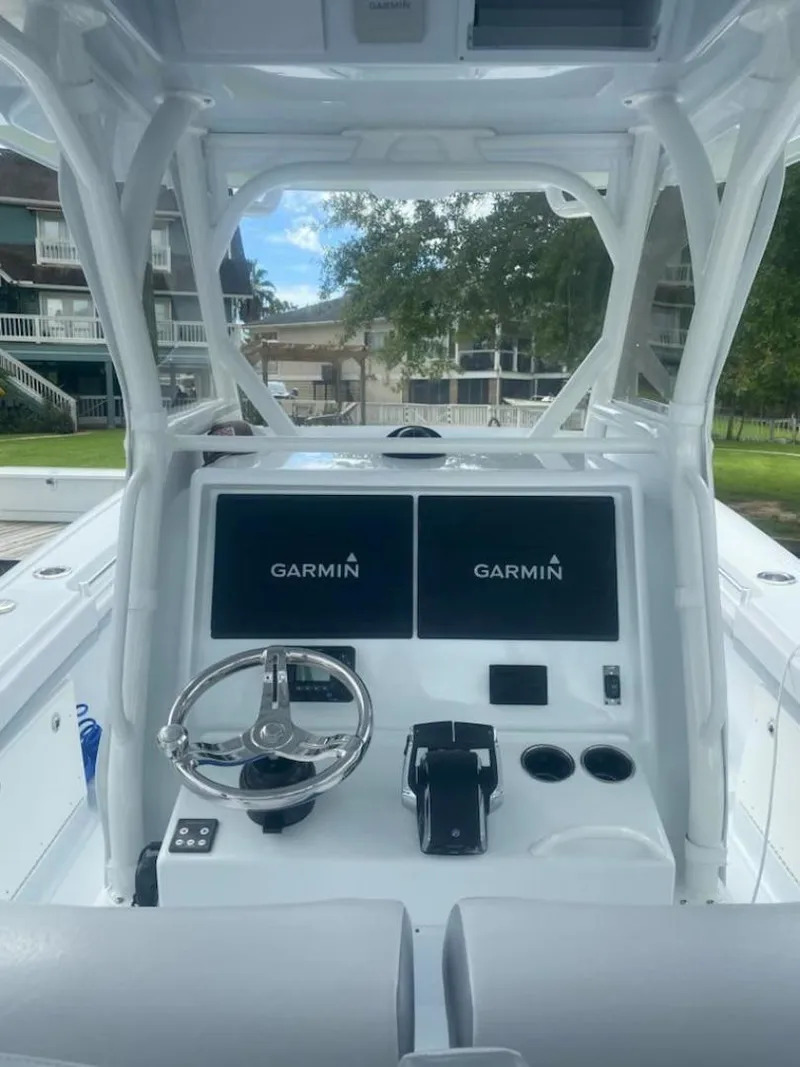 Slide: The Image of 2022 Yellowfin 32 boat dashboard with dual Garmin displays and steering wheel. - 8