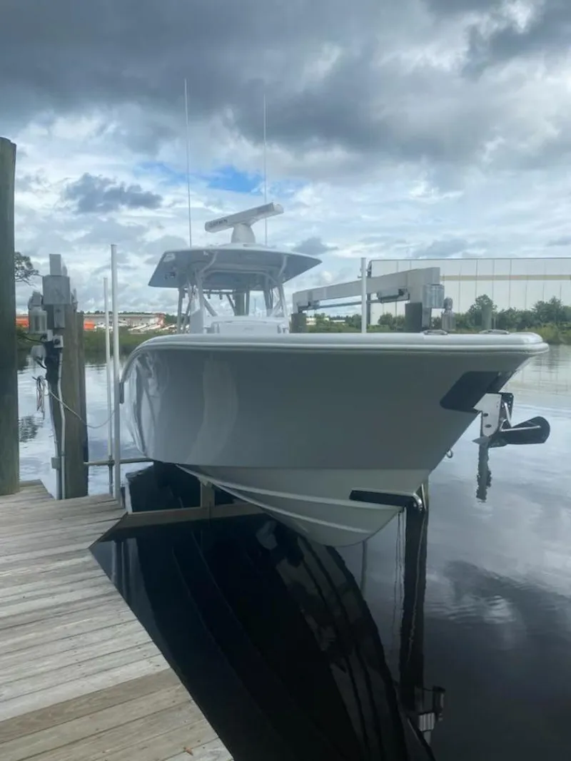 Slide: The Image of 2022 Yellowfin 32 boat docked under cloudy skies. - 9