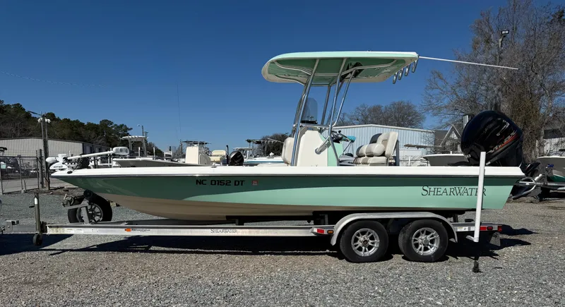The Image of 2011 ShearWater 2200 boat on trailer, side view, outdoors, clear sky. - 2