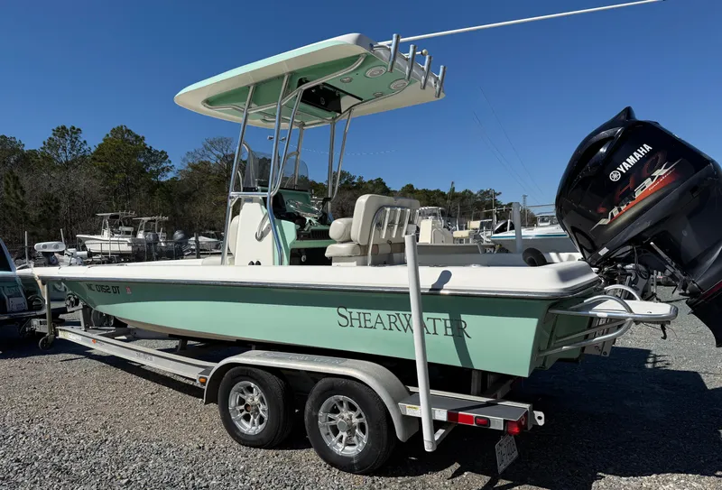 Slide: The Image of 2011 ShearWater 2200 boat on trailer with Yamaha outboard motor, parked outdoors. - 4