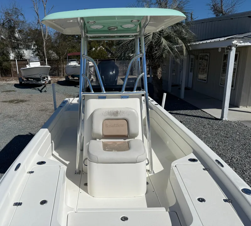 Slide: The Image of 2011 ShearWater 2200 boat with T-top and seating, parked outdoors. - 5