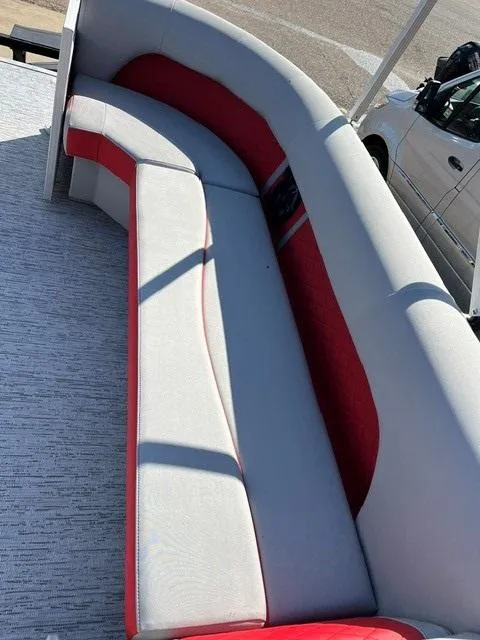 Slide: The Image of 2025 Bennington 21L Cruise boat interior with red and gray seating. - 10