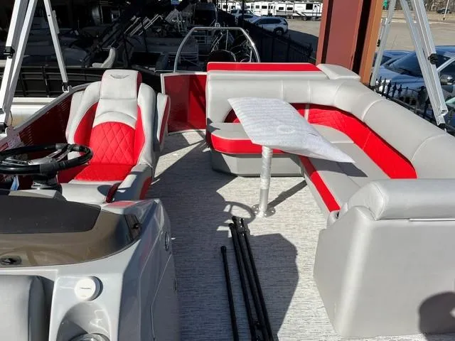 Slide: The Image of 2025 Bennington 21L Cruise pontoon boat interior with red and gray seating. - 14