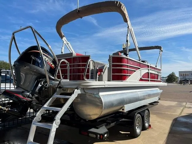 Slide: The Image of 2025 Bennington 21L Cruise pontoon boat on trailer, featuring red accents and Yamaha outboard motor. - 3
