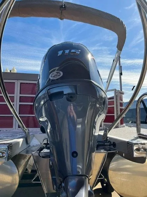 Slide: The Image of 2025 Bennington 21L Cruise pontoon boat with 115 horsepower engine, viewed from the rear. - 4