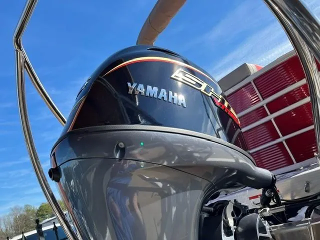 Slide: The Image of Yamaha outboard motor on 2025 Bennington 21L Cruise boat under clear blue sky. - 5
