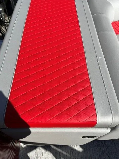Slide: The Image of Red and gray seating on 2025 Bennington 21L Cruise boat, featuring diamond stitching. - 8
