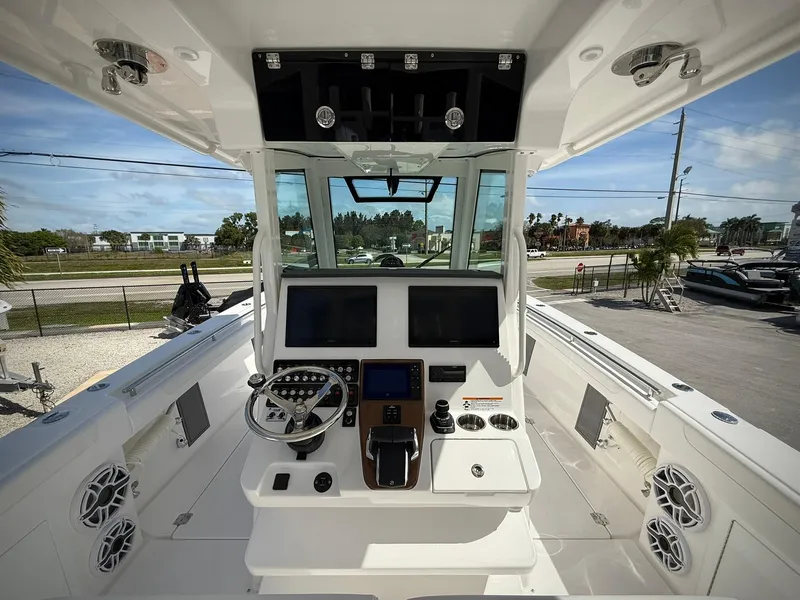 Slide: The Image of 2025 Caymas 34 CT boat cockpit with modern navigation controls and dual screens. - 11