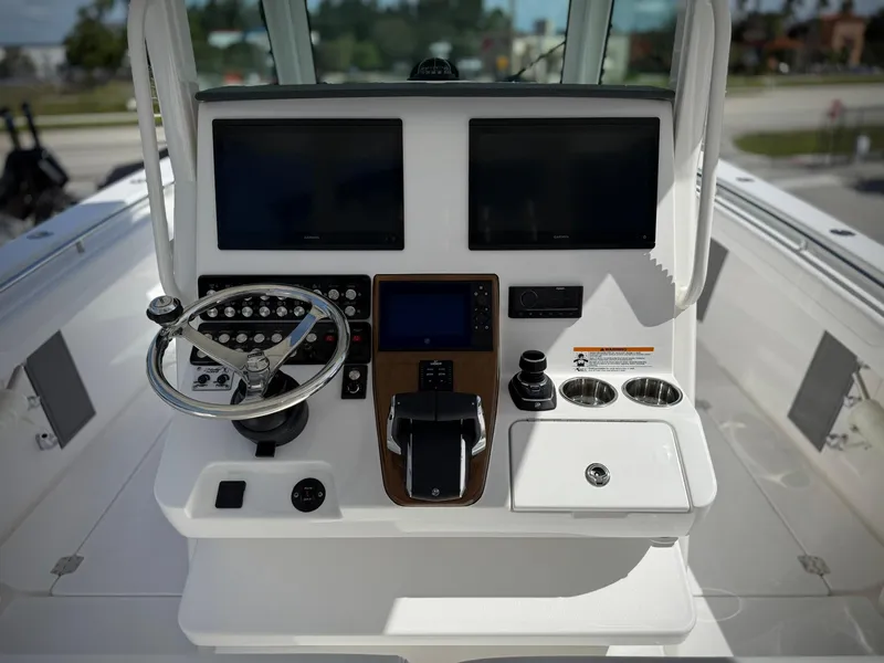 Slide: The Image of 2025 Caymas 34 CT boat dashboard with dual screens and steering wheel. - 12