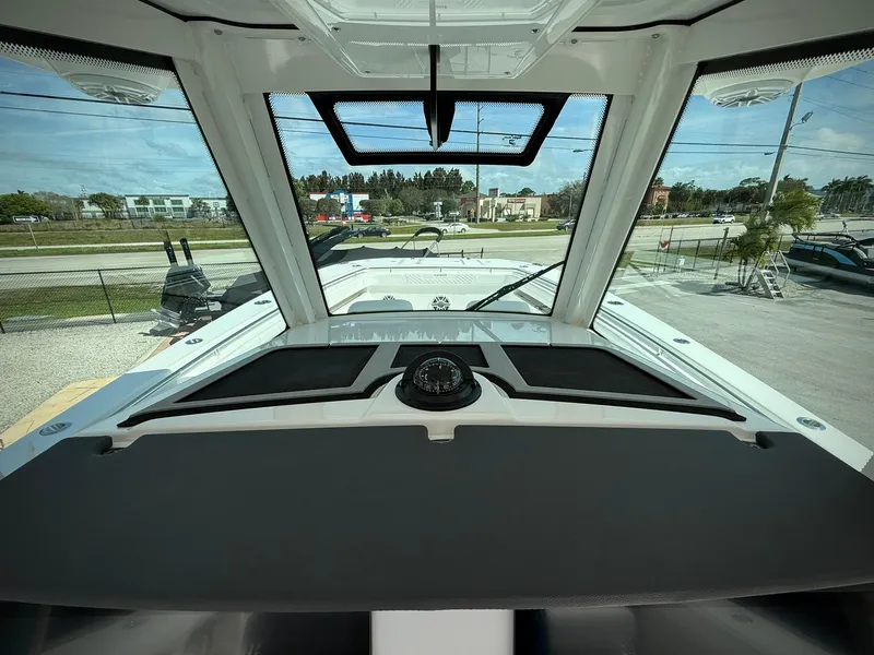 Slide: The Image of Interior view of 2025 Caymas 34 CT boat cockpit with windshield and dashboard. - 13