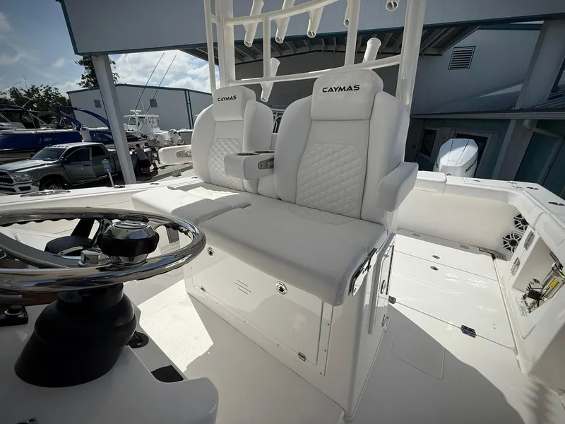 Slide: The Image of 2025 Caymas 34 CT boat interior with white seating and steering wheel. - 14