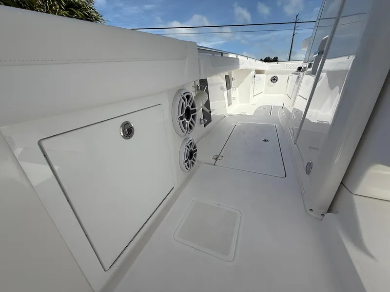 Slide: The Image of 2025 Caymas 34 CT boat interior with speakers and storage compartments. - 15