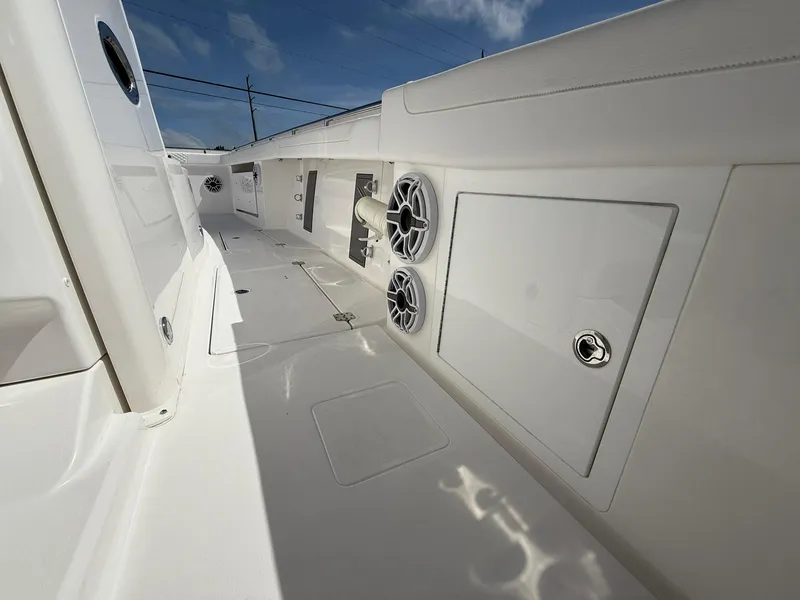 Slide: The Image of 2025 Caymas 34 CT boat interior with speakers and storage compartments. - 16