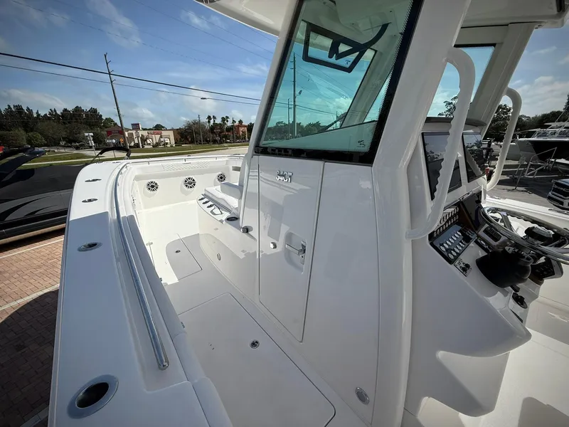 Slide: The Image of 2025 Caymas 34 CT boat deck with modern controls and seating. - 17