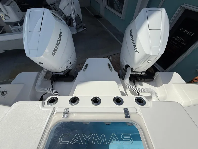 Slide: The Image of 2025 Caymas 34 CT boat with dual Mercury engines, rear view. - 2