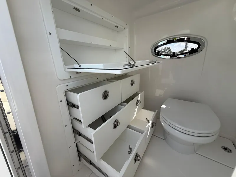 Slide: The Image of 2025 Caymas 34 CT boat bathroom with storage cabinets and a toilet. - 21