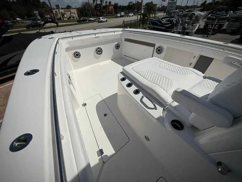 Slide: The Image of 2025 Caymas 34 CT boat interior with white seating and speaker system. - 24