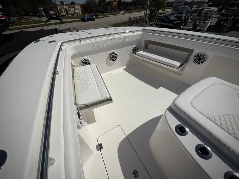 Slide: The Image of 2025 Caymas 34 CT boat interior with white seating and cup holders. - 26