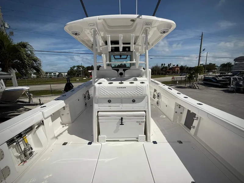 Slide: The Image of 2025 Caymas 34 CT boat interior, featuring spacious deck and modern design under clear skies. - 4