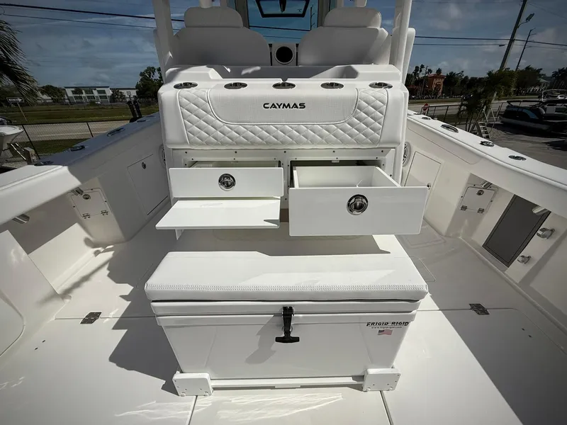 Slide: The Image of 2025 Caymas 34 CT boat interior with open storage drawers and seating. - 5