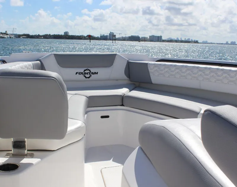 Slide: The Image of 2025 Fountain 32 NX boat interior with luxurious seating on a sunny day. - 10