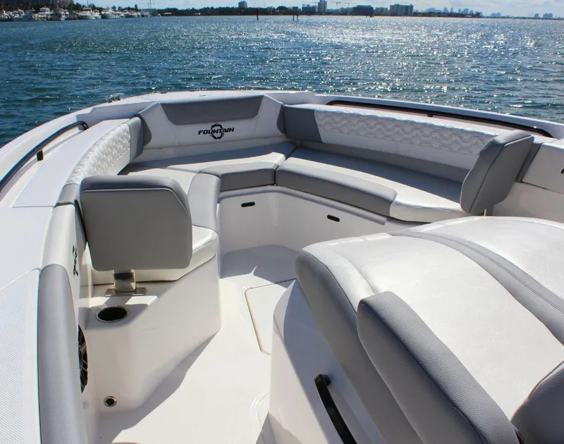 Slide: The Image of 2025 Fountain 32 NX boat interior with luxurious seating on a sunny day. - 12