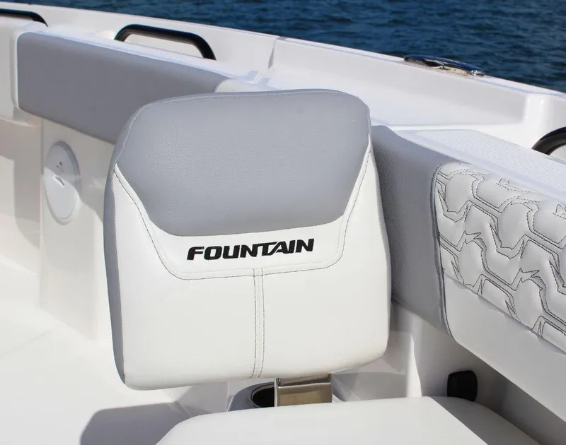 Slide: The Image of 2025 Fountain 32 NX boat seat with logo, featuring sleek white and gray design. - 15