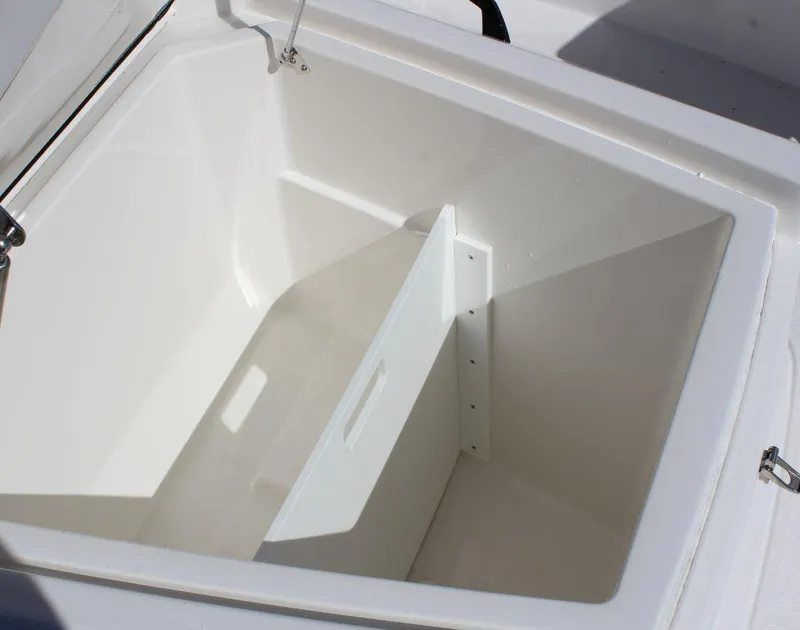 Slide: The Image of 2025 Fountain 32 NX boat storage compartment, open and empty, with white interior. - 17